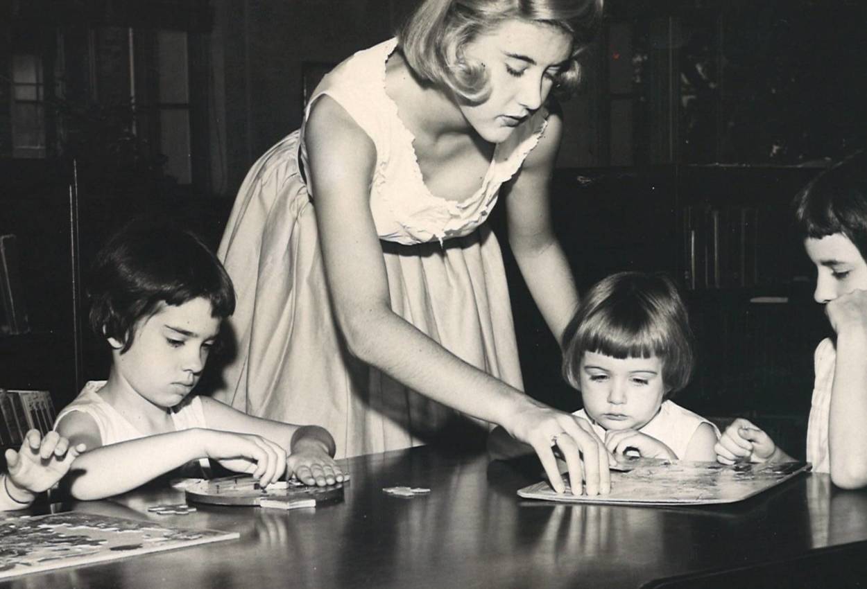 Photograph of woman reading to children